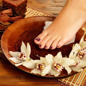 Closeup photo of a female foot at spa salon on pedicure procedure - Soft focus image